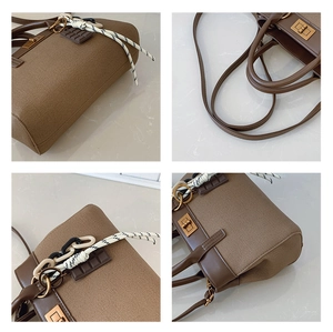 Détails d'un sac à main marron avec fermoir métallique et charms décoratifs
