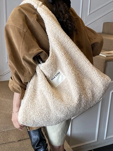 Large white faux shearling tote bag with SEEYOU label shown on a model's shoulder
