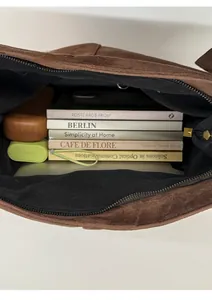 Detail view of deep brown velvet tote interior showing large capacity for books and devices