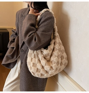 Detail of soft plush checkerboard shoulder bag in cream and coffee brown colors