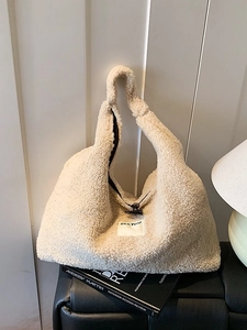 Cream white faux shearling tote bag with fuzzy texture and toggle closure design
