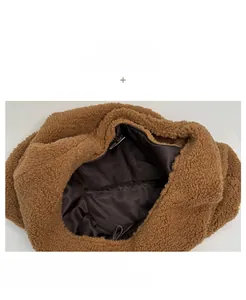 Close-up of brown faux shearling shoulder bag featuring soft plush texture and satin lining