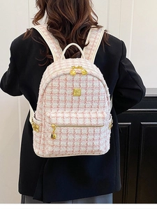 Pink and white tweed quilted backpack with gold metal hardware on model back