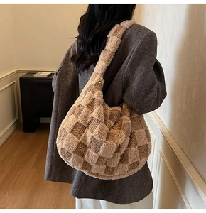 Detail view of the soft plush checkered hobo bag showing texture and crossbody strap length