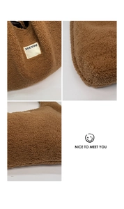 Detailed close-up of brown faux shearling fabric, stitching, and SEEYOU woven label
