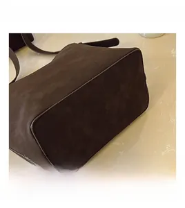 Detail shot of vintage dark brown tote bag showing premium matte texture and stitching