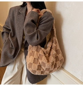 Detail of plush checkered hobo bag showing brown fuzzy texture and large capacity