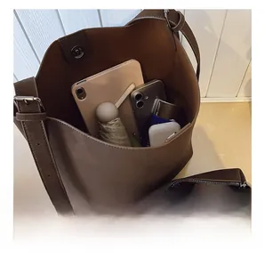 Top-down view of spacious dark brown bucket bag interior showing capacity for daily items