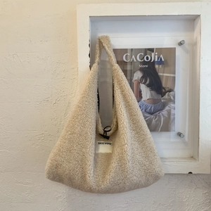 Detail of beige fleece tote bag featuring a black toggle closure and SEEYOU woven label