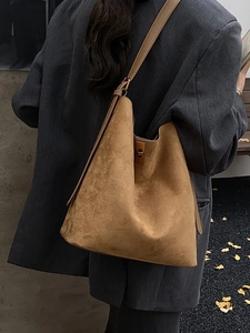 Brown suede bucket tote bag with leather strap and gold clasp, stylish commuter style