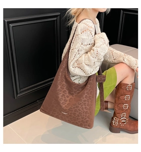 Brown leopard print suede tote bag styled with a knitted sweater and boots for autumn