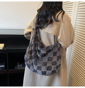 Detail view of large grey checkerboard plush hobo bag with soft faux fur texture