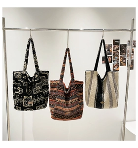 Detailed view of three patterned plush tote bags with our love labels on hangers