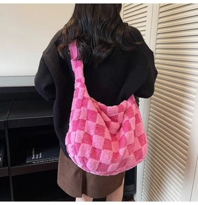 Macro shot of pink checkered plush shoulder bag showing soft faux fur texture and pattern