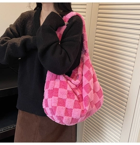 Detailed close-up of pink checkered plush tote bag with soft faux fur texture and large capacity