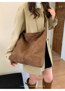 Brown suede minimalist retro crossbody bag styled with autumn outfit in cozy setting
