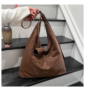 Close-up of the leopard print hobo bag showing the knot handle detail and textured fabric