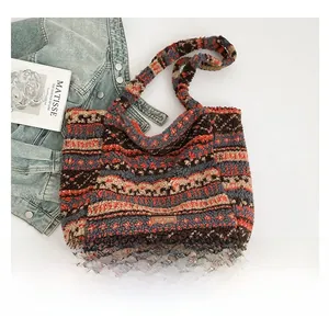 Detailed close-up of ethnic geometric pattern plush tote bag with branded leather label