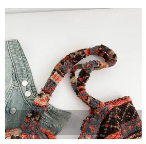 Detail of multi-color patchwork faux fur tote bag with plush texture and wide handle