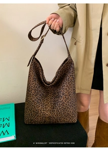 Detail view of leopard print hobo bag with adjustable strap worn on model shoulder