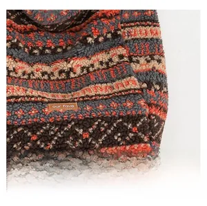 Close-up of bohemian pattern sherpa tote bag with premium leather brand label