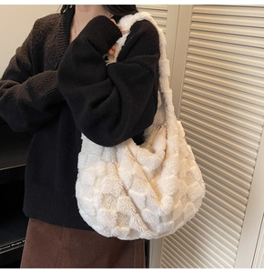 Fashionable white plush checkered tote bag worn by a model in a cozy indoor setting