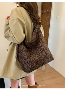 Detailed side view of large leopard print hobo bag showing retro minimalist texture