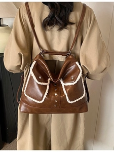 Brown faux leather backpack with white shearling trim and metal studs for women