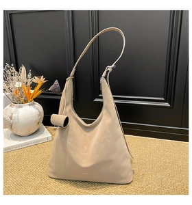 Detailed close-up of apricot Hobo bag with soft PU leather texture and thin shoulder strap