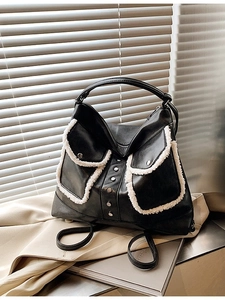 Black vintage tote backpack with white faux fur trim and silver buckles on shutter background