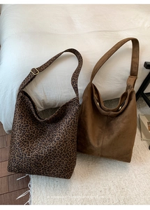 Detail of leopard print and solid brown tote bags with wide adjustable shoulder straps