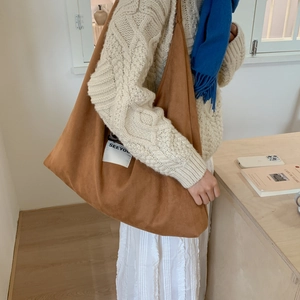 Detailed side view of brown lamb wool tote bag featuring a white SEEYOU woven label