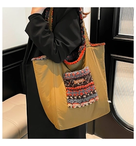 Detail shot of olive green tote bag featuring multi-colored fleece pocket and brand label