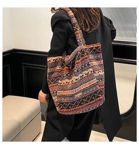 Detailed side view of ethnic style tote bag with geometric patterns and fuzzy texture