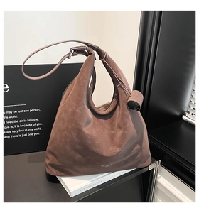 Macro detail of retro brown hobo bag with matte leather texture and wide shoulder strap