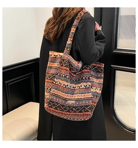 Close-up of bohemian geometric knit tote bag with lamb wool texture on a model