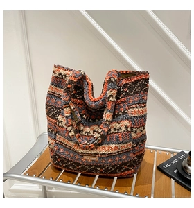 Macro detail of ethnic totem pattern on plush lamb wool tote bag with leather tag