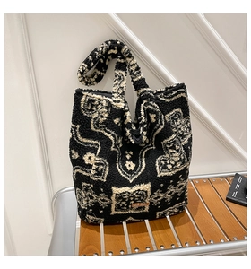 Detail of bohemian jacquard sherpa tote bag featuring plush texture and leather tag