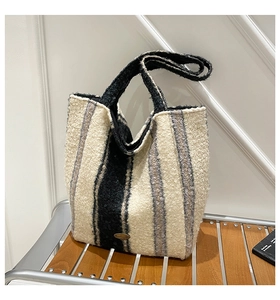Detail of ethnic style fleece tote bag with contrast vertical stripes and logo