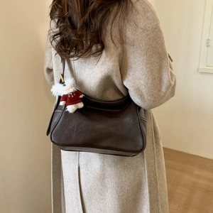 Brown retro leather crossbody bag with a cute white bear keychain on the side detail