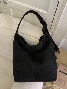 Classic black suede hobo shoulder bag with adjustable strap for women in a chic room