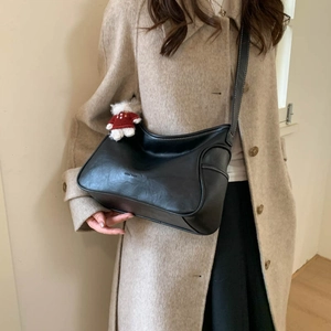 Minimalist black PU leather hobo shoulder bag with contrast stitching and bear charm