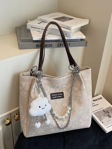 Beige floral canvas tote bag with brown leather straps and pearl chain accessory