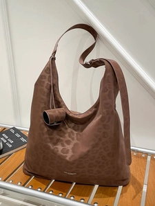 Brown leopard print large capacity hobo bag with wide strap and pouch on stairs