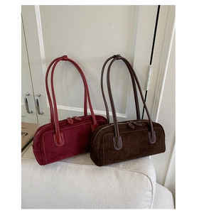 Detail of vintage Boston handbags in burgundy and brown with white contrast stitching