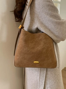 Vintage brown suede bucket bag with adjustable strap and golden metal hardware