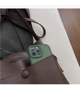 Detail view of the brown leather shoulder bag front pocket showing phone storage space