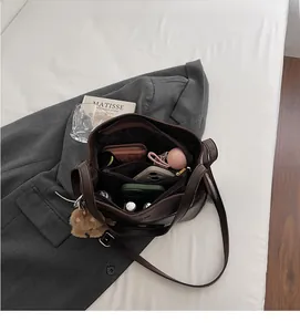 Top view of the spacious interior compartments of the dark brown leather bucket bag