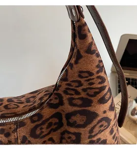 Detail shot of the reinforced stitching and silver zipper on this leopard print tote bag
