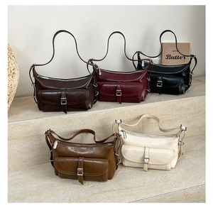 Detail view of stylish pillow bags in five colors with unique side metal rings